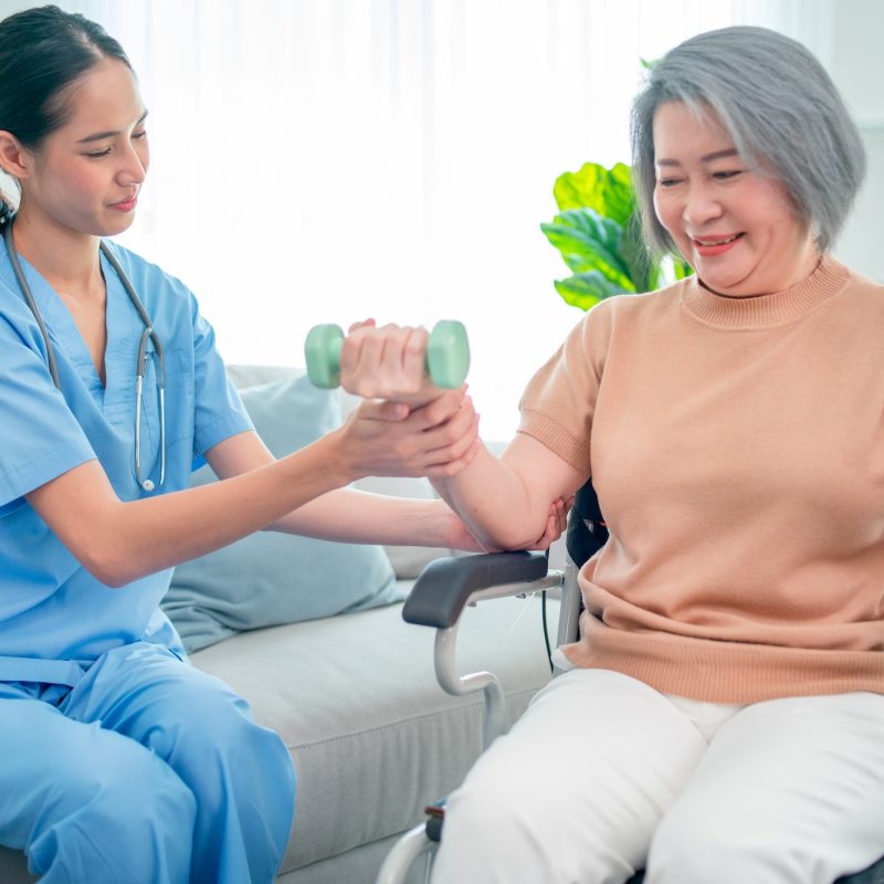 Nurse helping with weight / strength training